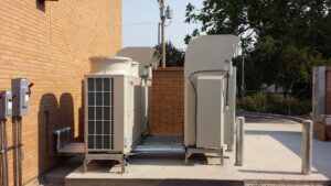 Large commercial HVAC units installed outside a brick building by ABT Heating and Cooling in Orem, UT.