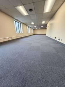 A large commercial office space with new blue carpet tile installation by Basics Flooring in Natick, MA.