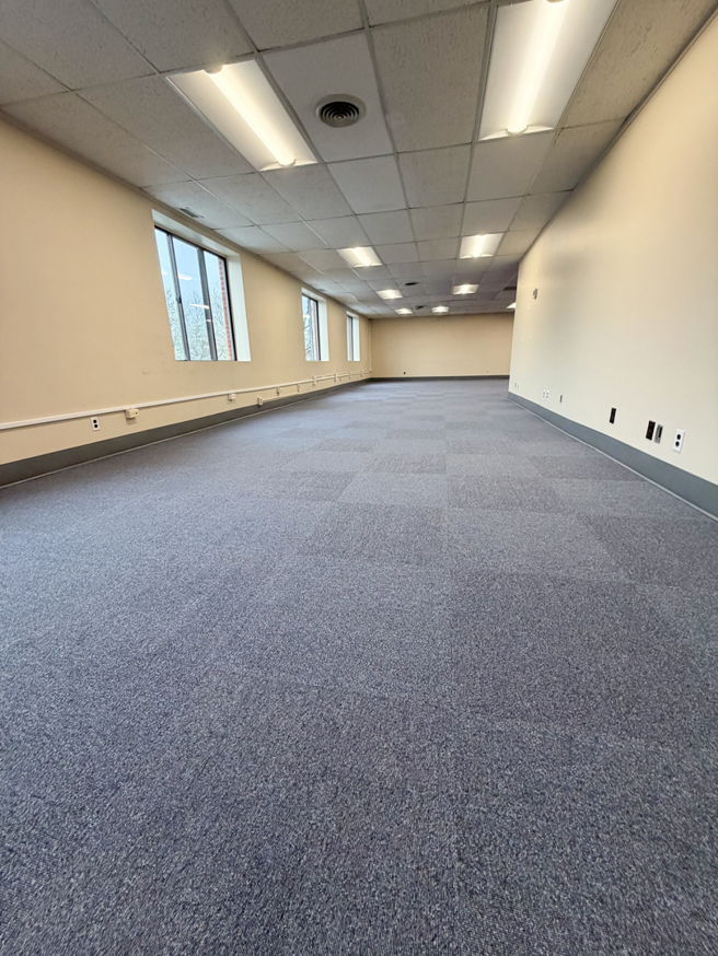 A large commercial office space with new blue carpet tile installation by Basics Flooring in Natick, MA.