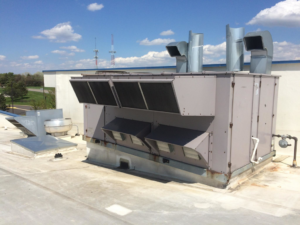 A large commercial rooftop HVAC system with multiple vents and ducts, installed by Corbe Heating and Air Conditioning in Elgin, IL.