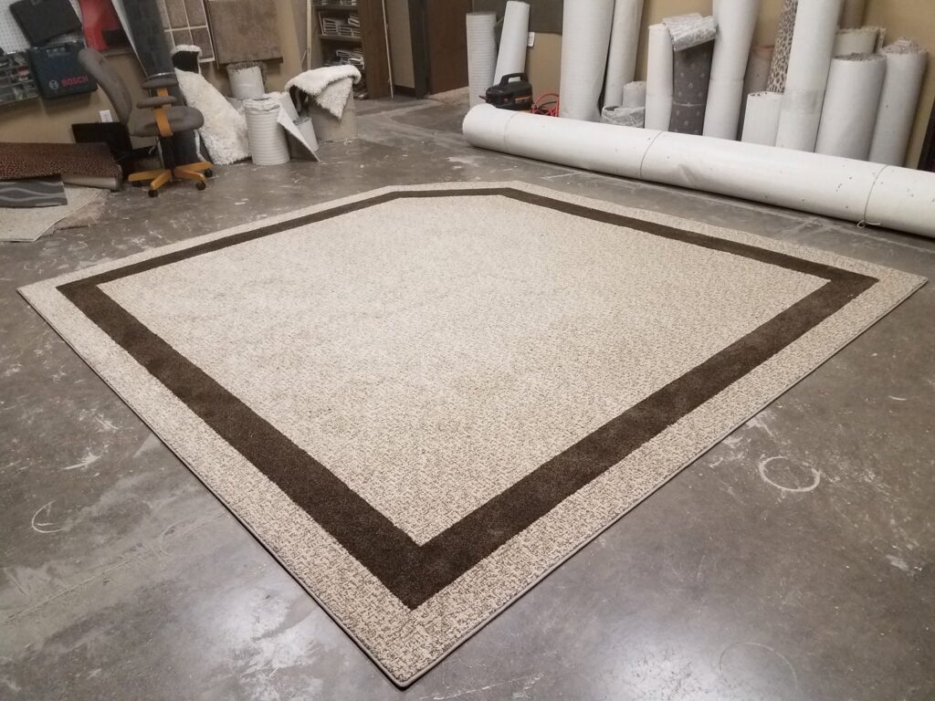 A large custom area rug with a dark brown border and bound edges, created by Carpet Binding By Scott in Oklahoma City, OK