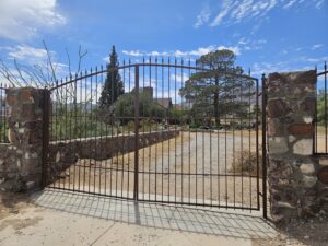 A large decorative metal driveway gate installed by Iron Man Exteriors in Las Cruces, NM.