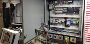 Interior view of a large electrical control panel with circuit breakers and wiring by J&L Electric Inc. in San Antonio, TX