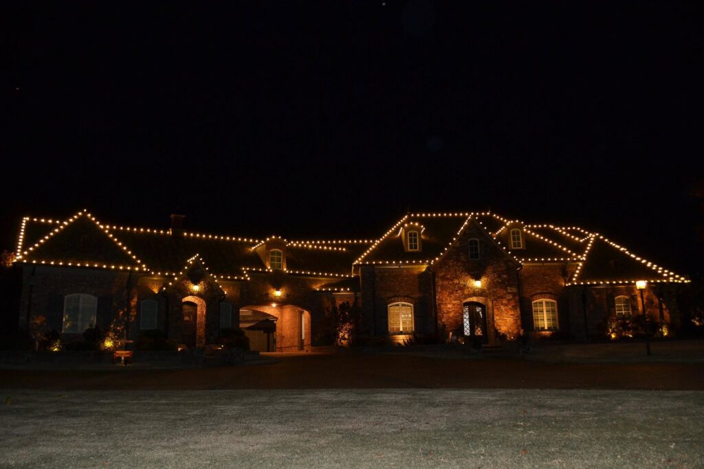 A large home beautifully lit with exterior lighting installed by Precision Electric and Lighting Services, LLC in Olive Branch, MS.