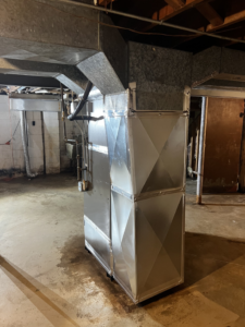 A large indoor air handler with extensive ductwork installed by Kai's Heat & Cool in Naperville, IL