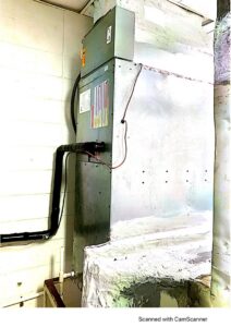 A large indoor air handler or furnace unit with ductwork connections installed by McGuffee's Air Conditioning and Heating in Gulfport, MS