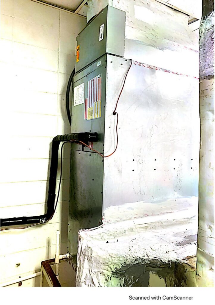 A large indoor air handler or furnace unit with ductwork connections installed by McGuffee's Air Conditioning and Heating in Gulfport, MS