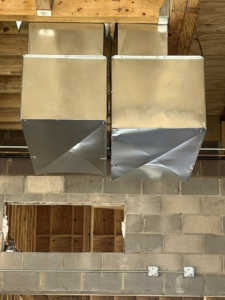 Large sections of metal HVAC ductwork installed in a commercial space by Airman Solutions Inc in Oklahoma City, OK