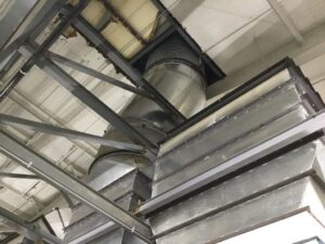 Large metal HVAC ductwork installed within a commercial building by Central Consolidated in Wichita, KS