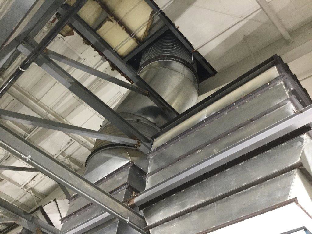 Large metal HVAC ductwork installed within a commercial building by Central Consolidated in Wichita, KS