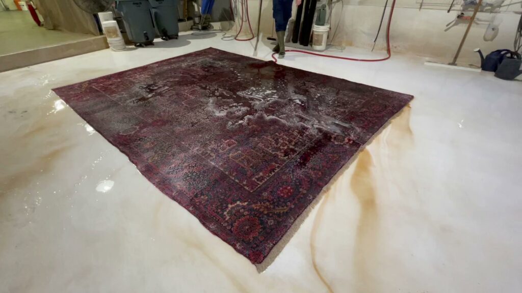 A large oriental rug undergoing a thorough cleaning process at Renaissance Rug Cleaning Inc. in Portland, OR.
