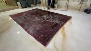 A large oriental rug undergoing a thorough cleaning process at Renaissance Rug Cleaning Inc. in Portland, OR.