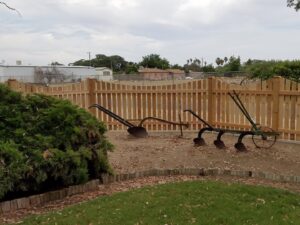 A large ornate wrought iron gate with brick pillars, providing an elegant entrance by The Fence Company in Fresno, CA.