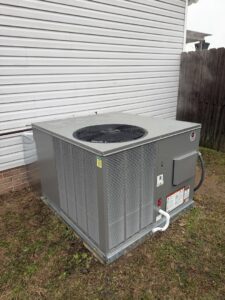 A large, clean outdoor HVAC unit newly installed next to a residential building by Mission HVAC in Huntsville, AL.