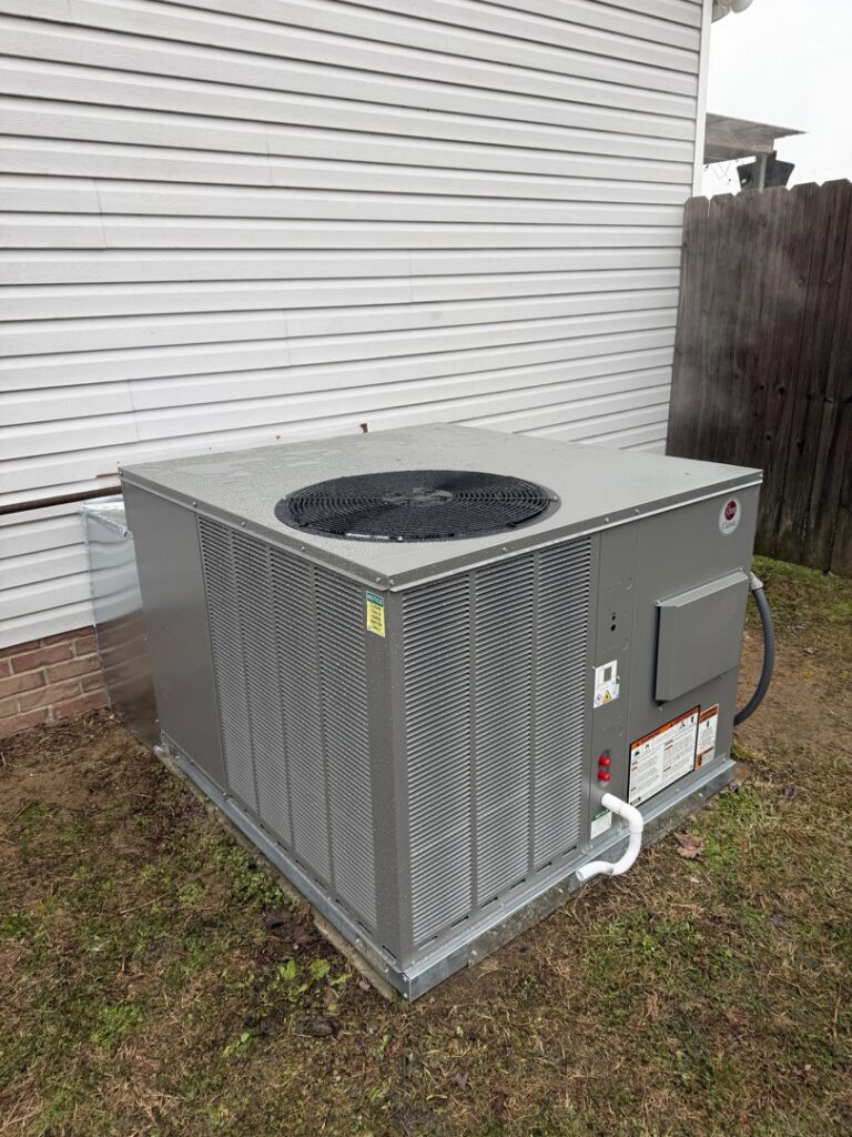 A large, clean outdoor HVAC unit newly installed next to a residential building by Mission HVAC in Huntsville, AL.