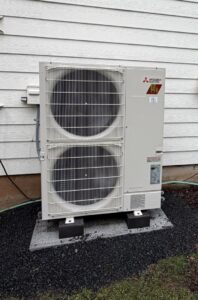 A large outdoor multi-zone Mitsubishi Electric heat pump unit professionally installed by The Heat Pump Store in Portland, OR.