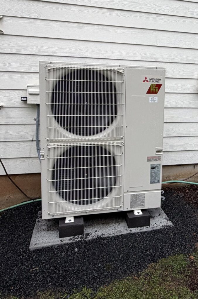 A large outdoor multi-zone Mitsubishi Electric heat pump unit professionally installed by The Heat Pump Store in Portland, OR.