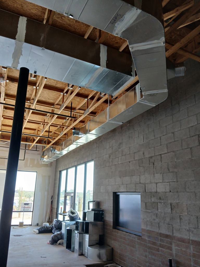 Large rectangular HVAC ductwork installed inside a building under construction by BH cooling & Heating in Glendale, AZ.