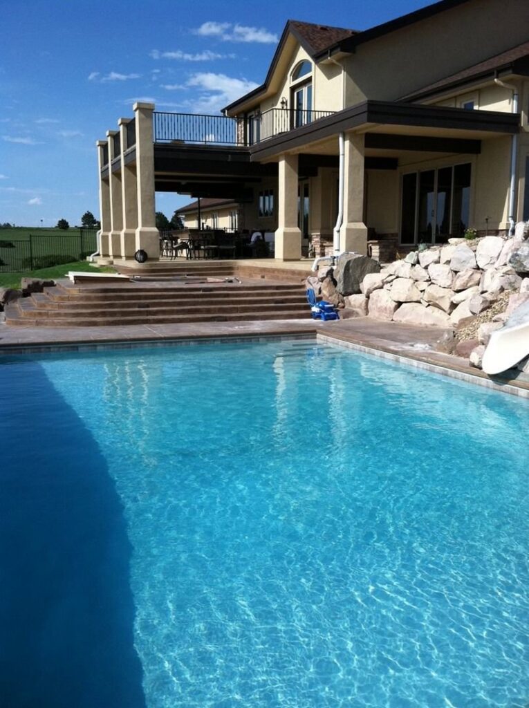 A spacious residential pool in a landscaped backyard, completed by Wetworks Pool and Spa in Englewood, CO.