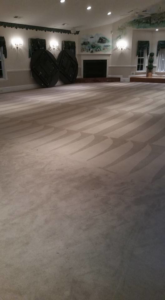 A large room with freshly cleaned carpet showing distinct patterns from the cleaning process by Chichi Carpet Cleaning in High Point, NC