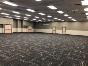 A large room showcasing a new carpet installation with a modern pattern by Spokane Floormart Inc in Spokane, WA.