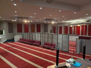 A large room with a vibrant red patterned carpet expertly installed by Musalla Masjid Carpets in Glendale Heights, IL.