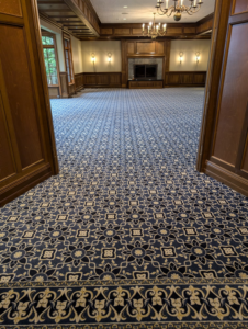 A large room showcasing newly installed patterned carpet by Craftmark Installations LLC in Broken Arrow, OK