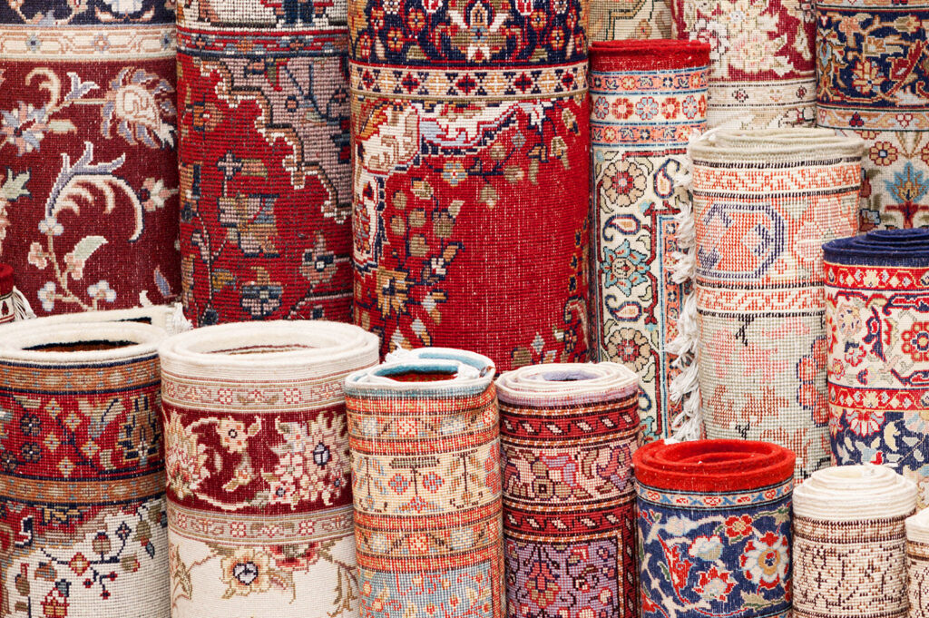 A large selection of various rolled carpets and rugs, indicating available inventory at Carpet Cleaner Staten Island in Staten Island, NY.