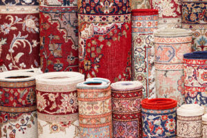 A large selection of various rolled carpets and rugs, indicating available inventory at Carpet Cleaner Staten Island in Staten Island, NY.