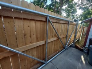A large sliding wooden privacy gate with a sturdy metal frame installed by First Rate Fence & Supply in Denver, CO.