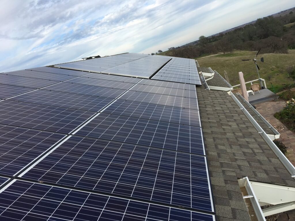 A large-scale solar panel installation on a residential roof by Solar & Electric Service Bros in West Sacramento, CA.