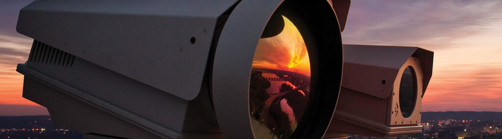 Large surveillance cameras overlooking a city at sunset, installed by Access Hardware Inc in Honolulu, HI