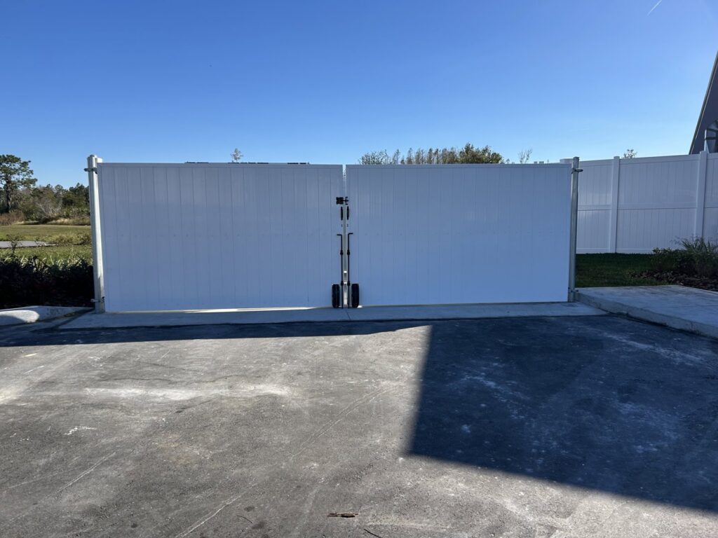 A large white vinyl double gate installed for a property entrance by Golden Eagle Fencing in Tampa, FL