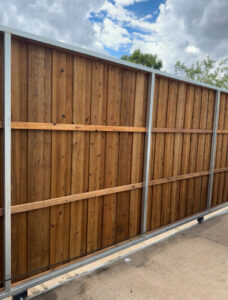 A large wood sliding gate with a durable metal frame installed by Franco Fence in Garland, TX.