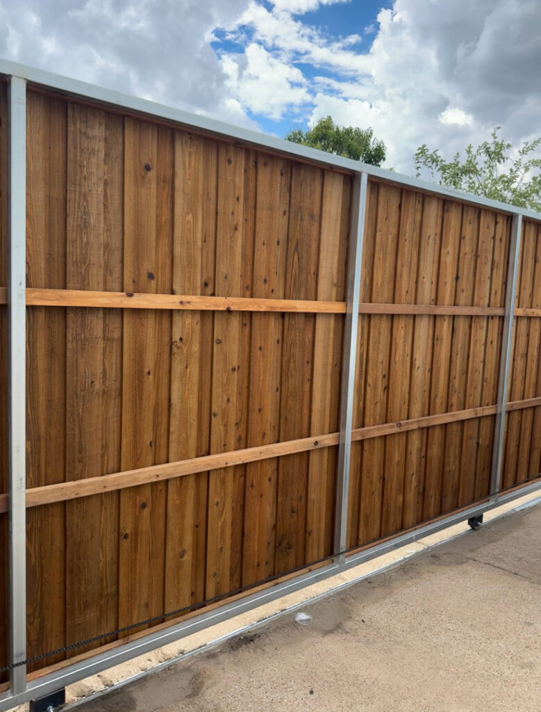 A large wood sliding gate with a durable metal frame installed by Franco Fence in Garland, TX.