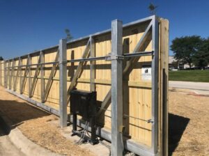 Large wooden sliding gate with metal frame and automation system by Gate Options in West Chicago, IL