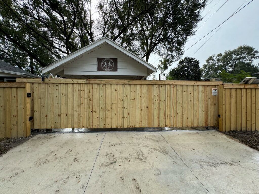 A large wooden sliding gate installed by Elite Fence and Outdoor of Tampa Bay in Tampa, FL.