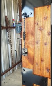 A large wooden sliding gate with a solar-powered opener installed by Ft Worth Fence And Patio in Fort Worth, TX.