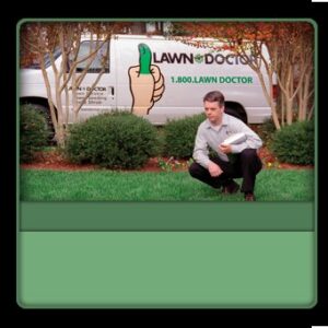 A Lawn Doctor specialist applying product to a lawn in Carmel, IN, with a company van in the background.