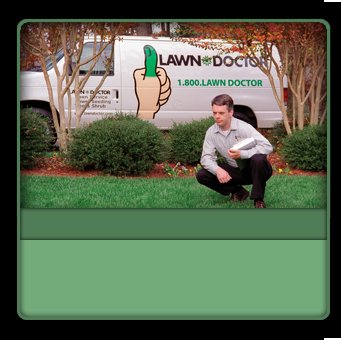 A Lawn Doctor specialist applying product to a lawn in Carmel, IN, with a company van in the background.