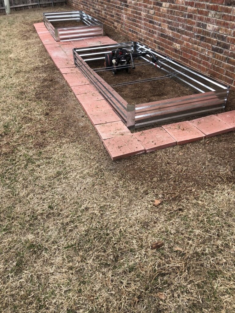 A lawn care worker using a string trimmer for edging and maintenance by A & A Lawn Care Service LLC in Moore, OK.