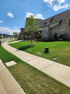 Lawn pest control devices strategically placed around a residential home by TDI Lawn & Pest - Birmingham, AL.