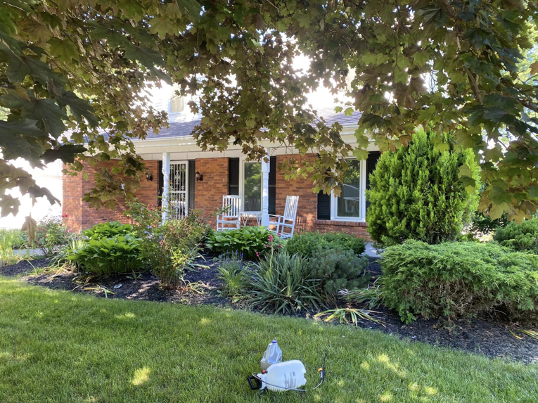 Lawn treatment sprayer in a well-maintained front yard by Sonner And Sons Lawncare in Fort Wayne, IN.
