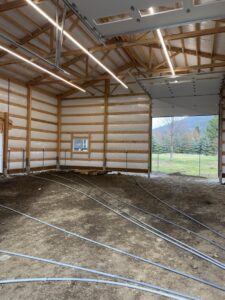 Linear LED lighting installed on the ceiling of a large building under construction by Interstate Electrical Contractors in Dalton Gardens, ID.