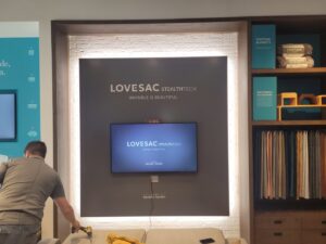 A display wall with a mounted TV and decorative LED strip lighting installed by KS Retail Solutions in Victoria, TX