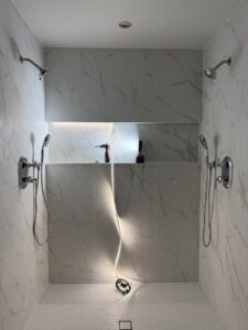 LED strip lighting installation in a shower niche, with tools visible, by Kot Electric LLC in Kent, WA.