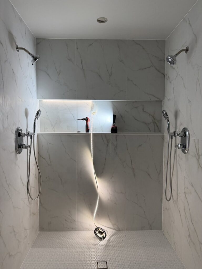 LED strip lighting installation in a shower niche, with tools visible, by Kot Electric LLC in Kent, WA.