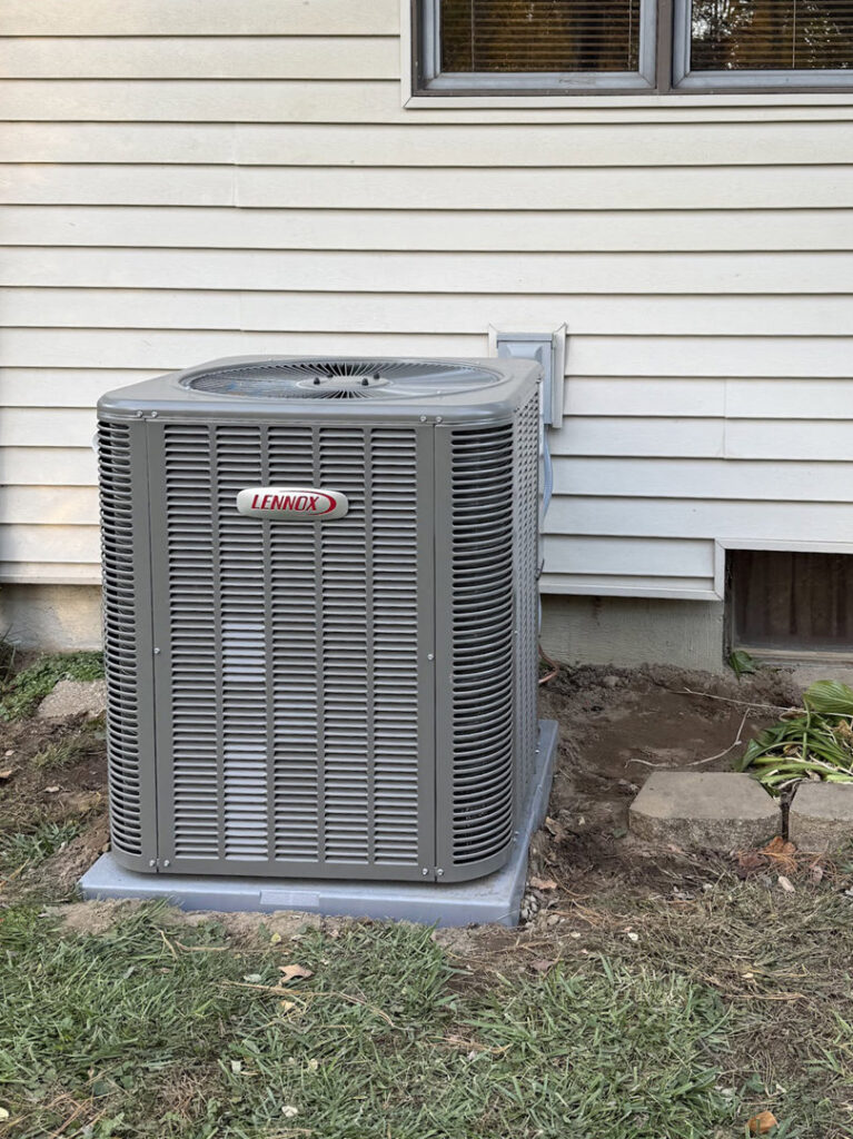 An outdoor Lennox AC condenser unit professionally installed by Home Run Mechanical in Ann Arbor, MI.