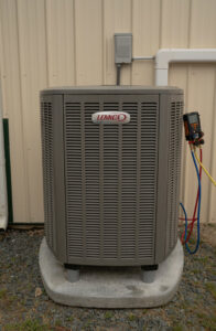 An outdoor Lennox AC condenser unit being serviced with gauges by Seven Level Services Inc in Cape Coral, FL.