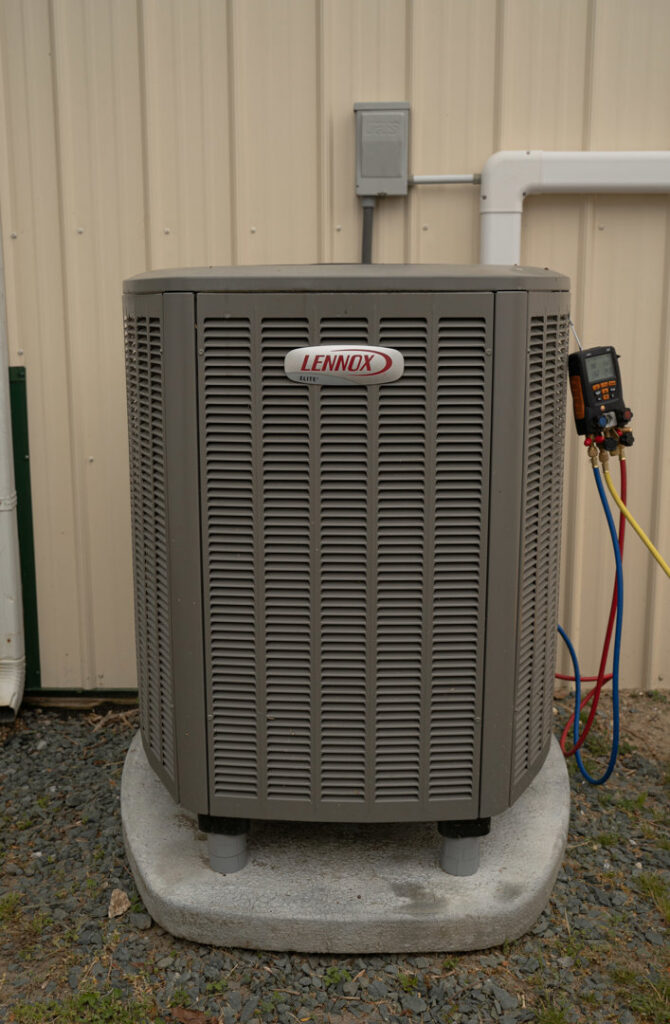 An outdoor Lennox AC condenser unit being serviced with gauges by Seven Level Services Inc in Cape Coral, FL.